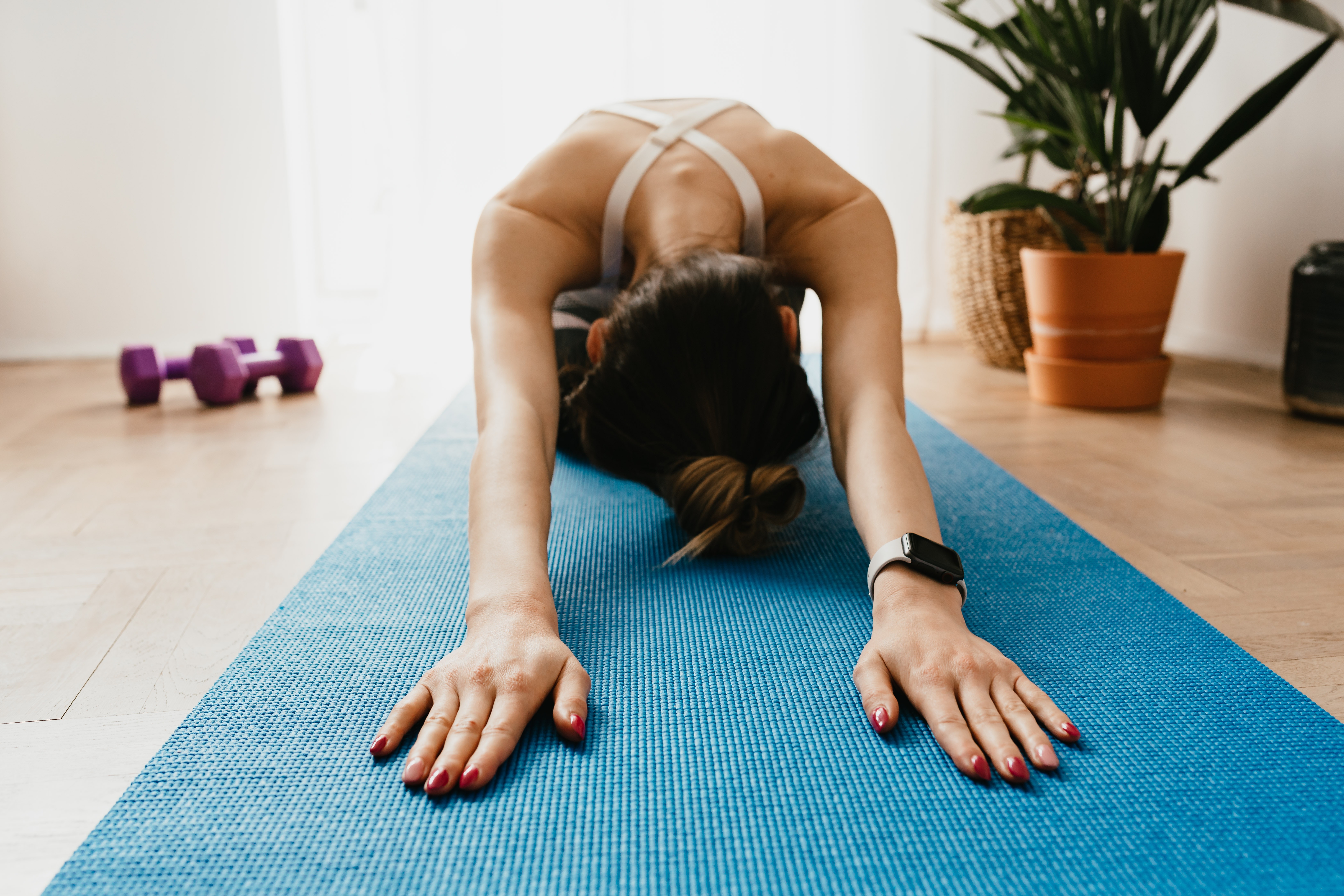 Woman stretching on yoga mat.